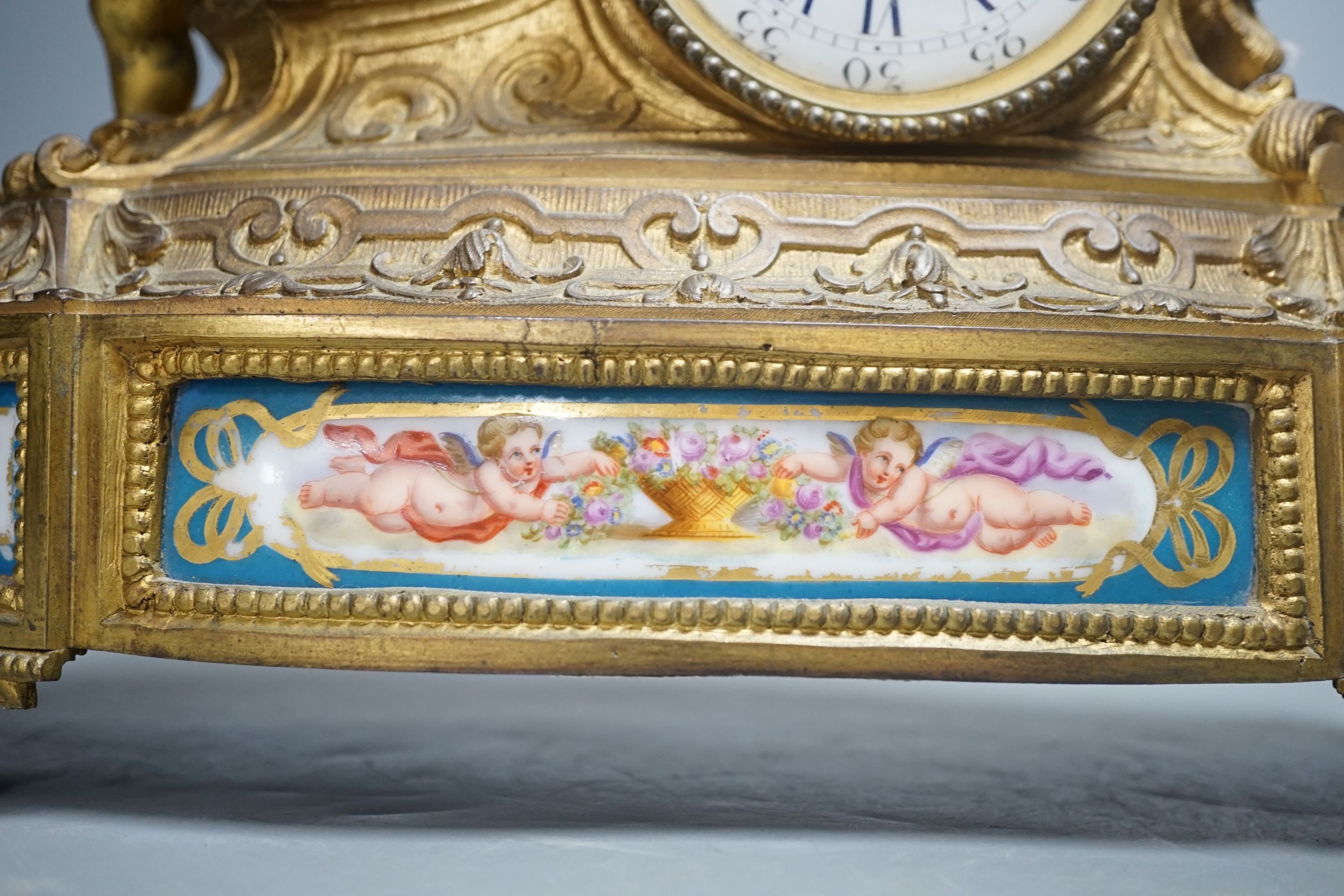 A French ormolu and Sevres style porcelain mounted putti mantel clock by Le Roy et Fils, Palais Royale, Paris, 26 cms high.